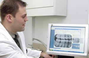 A person using a laptop to search for same day dental implant providers