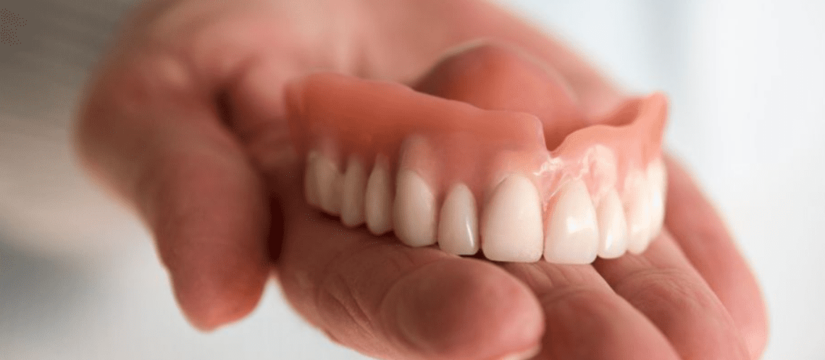 Denture is placed on hand