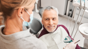 Dentist holding Dentures