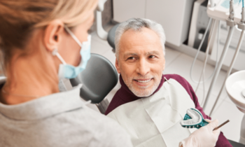 Dentist holding Dentures