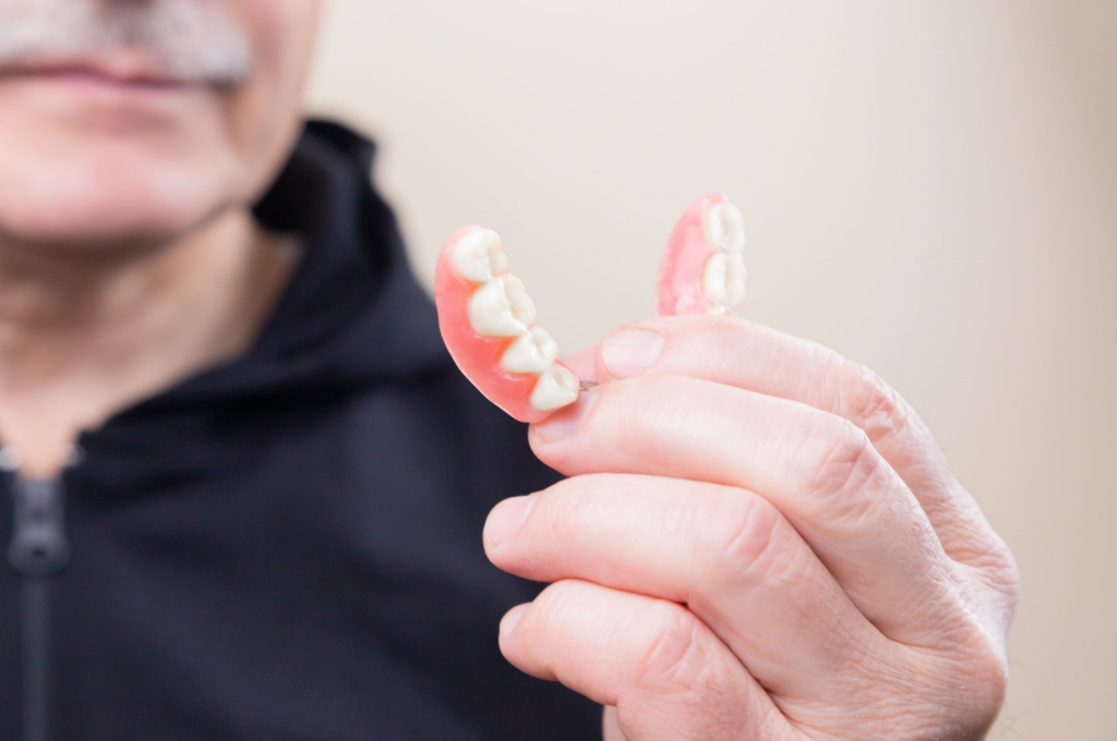 Holding Dentures in hand