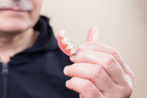 Holding Dentures in hand