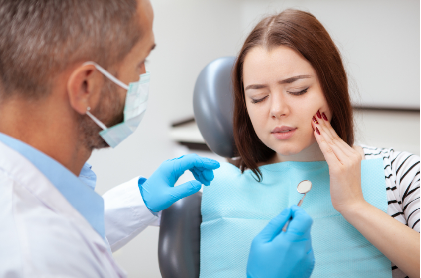 Woman with toothache at dentist