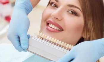 woman comparing her teeth shade after teeth whitening rockville md