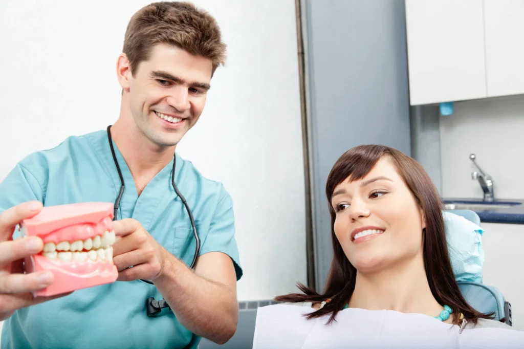 Girl shown by dentist a model of dentures rockville md