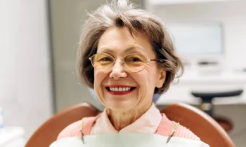 woman smiling and showing her new dentures rockville md